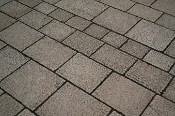 grey geometric paving stones close up, grey geometric tile surface 