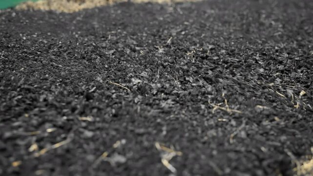 A pile of shredded tires being sorted and recycled in an industrial facility.