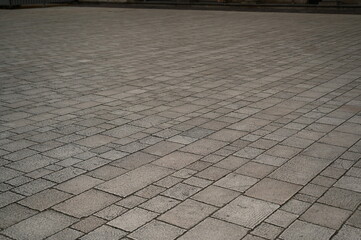 Fototapeta premium grey paving tile texture, grey tile pattern as background, grey tile texture close up 