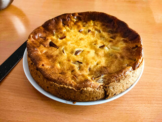 Homemade apple pie on a plate, ready to be served. Warm, inviting, and perfect for themes of...
