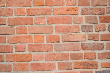 Red brick wall close up background. Vintage masonry texture of red bricks with mortar