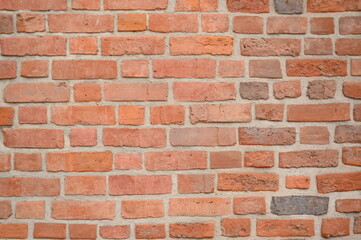 Red brick wall close up background. Vintage masonry texture of red bricks with mortar