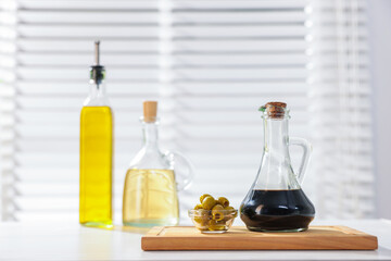 Salad dressings and olives on table in kitchen