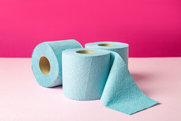 Blue toilet paper rolls on pink background