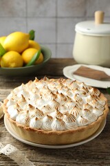 Delicious meringue pie on wooden table indoors