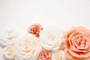 Beautiful paper flowers on white background, flat lay. Space for text