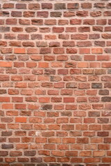 red brick wall texture close-up as background texture of a red brick wall with visible mortar lines and natural wear. ideal as a background for architectural, construction, design, or urban visuals.