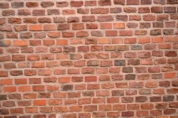 Obraz premium red brick wall texture close-up as background texture of a red brick wall with visible mortar lines and natural wear. ideal as a background for architectural, construction, design, or urban visuals.