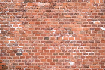 Old red brick wall texture with white efflorescence and weathered surface. Vintage masonry background for design, architecture, construction, and restoration projects. Rough textured red bricks with m