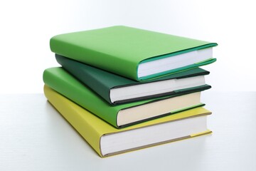 Stack of colorful books on white background