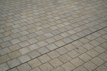 grey stone pavement with square tiles forming a geometric pattern