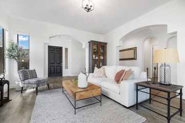 Cozy living room with a couch, coffee table, chairs, and a rug