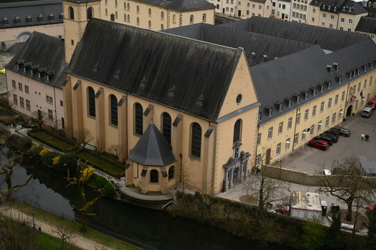 Aerial view of the historic European city center with old buildings, church towers, and green hills. Perfect for travel agencies, tourism marketing, architecture firms, and hospitality branding. The p