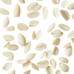 Scattered blanched almonds on a plain bright surface view isolated on white background