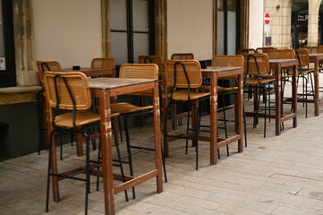 Cozy cafe interior with wooden tables and chairs. Vintage restaurant furniture in warm tones, ideal for hospitality, lifestyle, and design themes