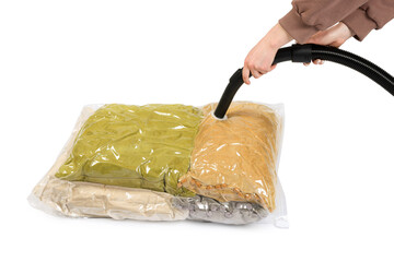 Woman sealing vacuum bag with clothes on white background, closeup