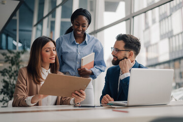 Business people collaborating on project in modern office