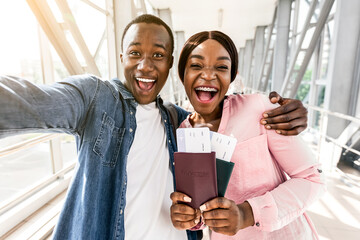 Finally Travelling. Excited African Couple Taking Selfie At Airport With Passports And Tickets, Excited About Vacation Trip, Closeup