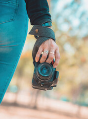 Woman photographer holding a professional camera, world photography day concept, copy space
