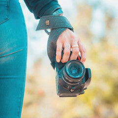 Woman photographer holding a professional camera, world photography day concept, copy space