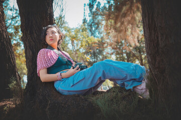 Young woman photographer holding a camera poses for the camera, photographer's day concept, has plenty of room to write.