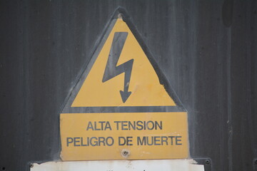 Warning sign indicating high voltage danger in an industrial area