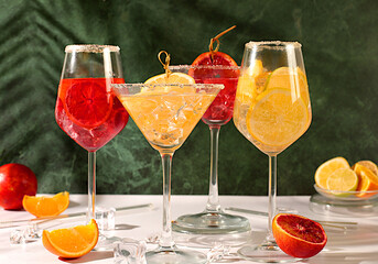 Banner with various glasses of alcoholic drinks and tropical fruits. Cocktails from fruits, ice cubes, rum and tequila. Summer party and relaxation concept. Menu for a bar or cafe