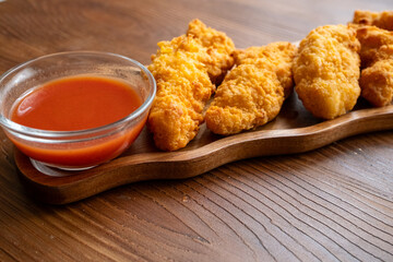 fried chicken in a glass bowl and ketchup
