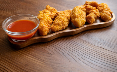 fried chicken in a glass bowl and ketchup