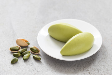 Modern Pistachio cream quenelles. On a plate. Close-up