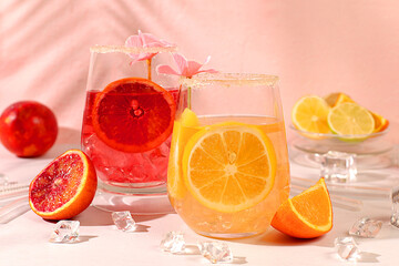 Royal cocktail of blood orange, lemon and lime, ice cubes, rum and tequila. Flyer with a glass of...