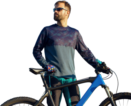 Cyclist in shorts and jersey on a modern carbon hardtail bike with an air suspension fork standing on a cliff against the background of fresh green spring forest