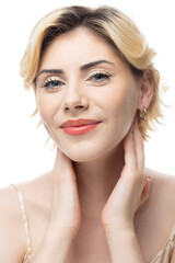 Fototapeta premium A young blonde girl with clear skin in a satin top. Beauty portrait of a woman on a white background in the studio.