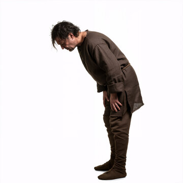 Poor medieval peasant man feeling nauseously ill and bending over forward - isolated on white