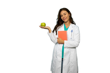 Female doctor holding a green apple and a notebook, promoting healthy eating habits on a...