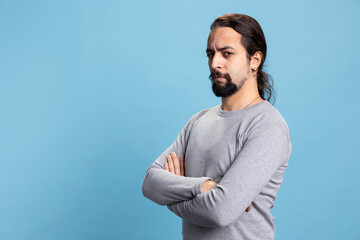 Male person standing against blue background with confidence, advertising a vibrant cool attitude...