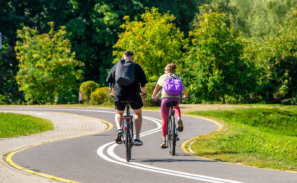 Cyclists ride on the bike path in the city Park