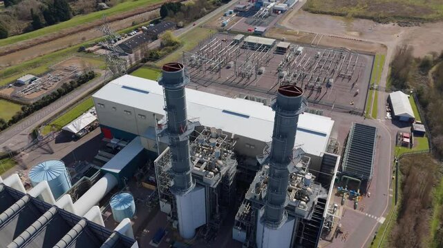 An industrial power station with twin chimneys stands next to the Lincolnshire Canal, UK