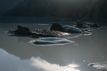 Blocks of ice from a glacier in a freezing cold lake in the mountains.