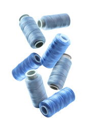 Many sewing threads in different shades of blue flying on white background
