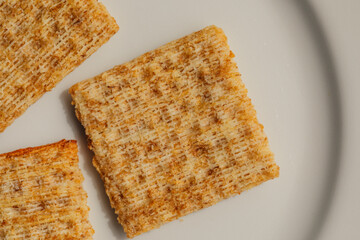 wheat crackers on a white plate	