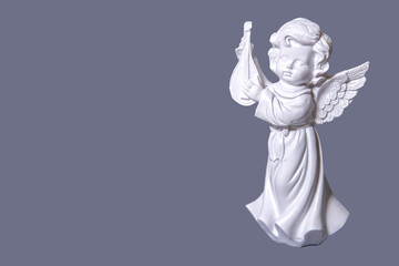 Obraz premium Figurine of an angel on a white background.