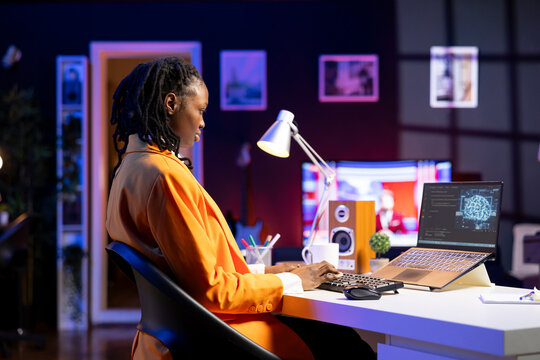 Computer scientist updating artificial intelligence neural networks, writing binary code scripts. Remote worker in apartment office uses digital device programming to upgrade AI