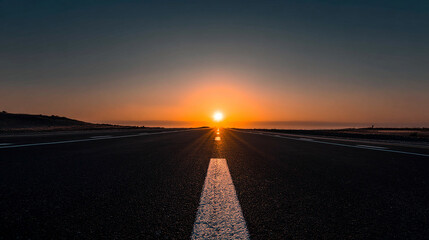 Naklejka premium Empty road stretching into a glowing sunrise