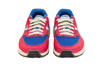 A front view of a pair of red and blue athletic shoes with laces on transparent background