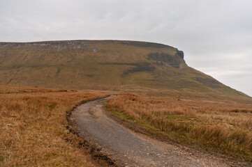 A road winds its way through a dry, barren landscape