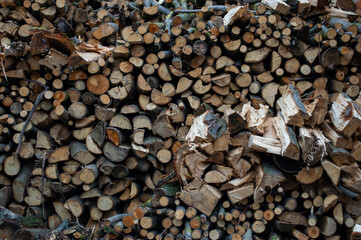 Fototapeta premium Close-up of neatly organized firewood, showcasing different sizes and textures of logs, ideal for a warm winter fire