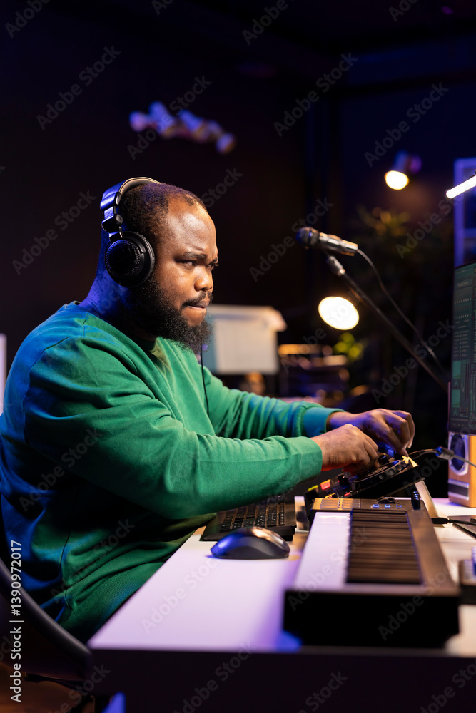 Poster african american music producer twisting knobs on mixing console, producing new tracks with sound ef