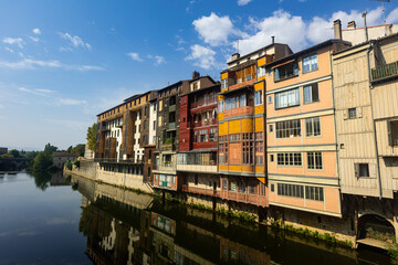 Scenic summer view of typical colorful townhouses on bank of Agout river in French town of Castres...