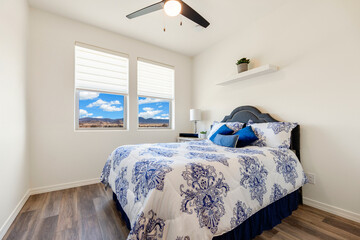 A cozy bedroom with a comfortable bed and ceiling fan for airflow